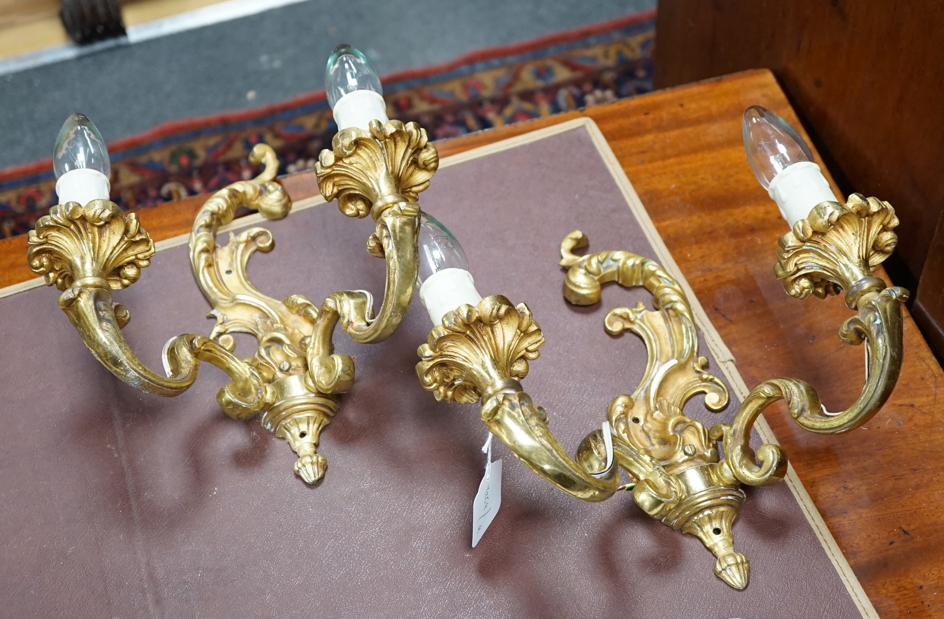 A pair of French ormolu two branch sconces, 27cms high